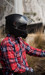 Motorcyclist man with a black helmet