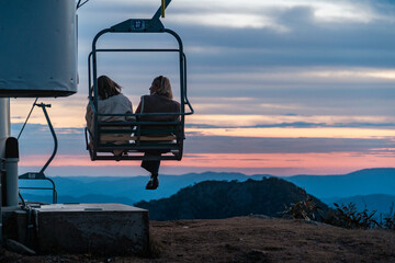 silhouette of a couple on a chairlift