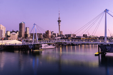 Auckland, New Zealand September 20 2021: The sun sets over the Viaduct marina and Auckland business district skyscrapers in New Zealand largest city
