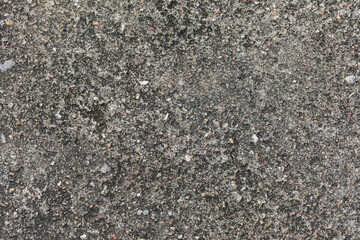 Gray textured cement wall background with fine concrete chips. Construction backgrounds