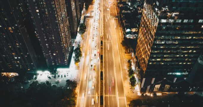 Aerial hyper lapse of Chengdu City urban cityscape at night of cars driving on the road with high office building by the side modern downtown