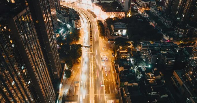 Aerial hyper lapse of Chengdu City urban cityscape at night of cars driving on the road with high office building by the side modern downtown