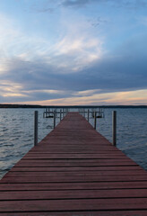 Fototapeta na wymiar Dock on Mullett Lake in Indian River Michigan with pastel skies overhead