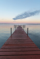 Fototapeta na wymiar Dock on Mullett Lake in Indian River Michigan with pastel skies overhead
