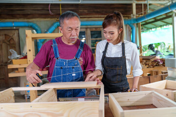 Tutor With Female Carpentry Student In Workshop Studying For Apprenticeship At College ,Teacher...