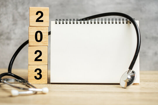 2023 Happy New Year for healthcare, Insurance, Wellness and medical concept. Stethoscope and blank notebook for copy space your text