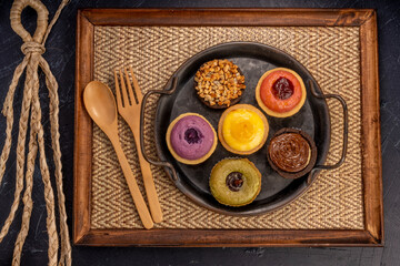 Egg Tart or Baked Cheese Tart in various flavors, purple potato, chocolate, vanilla cream, lemon, green tea and almond cream.