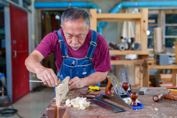 Occupation, carpentry, woodworking and people concept - carpenter test plank balance at workshop