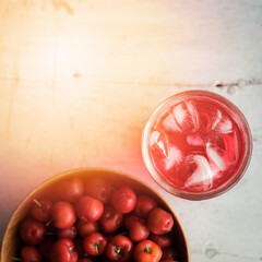Glass of sour cherry juice with fresh red cherries, Cherry juice, on wood background, red drink, High vitamin C and antioxidant fruits.