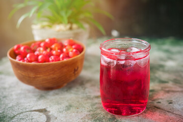 Glass of sour cherry juice with fresh red cherries, Cherry juice, on wood background, red drink, High vitamin C and antioxidant fruits.