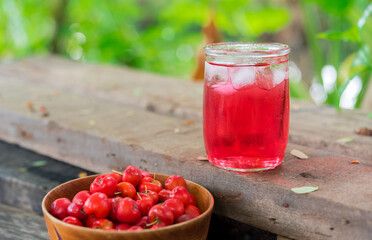 Glass of sour cherry juice with fresh red cherries, Cherry juice, on wood background, red drink, High vitamin C and antioxidant fruits.