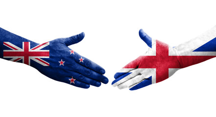 Handshake between Great Britain and New Zealand flags painted on hands, isolated transparent image.