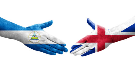 Handshake between Great Britain and Nicaragua flags painted on hands, isolated transparent image.