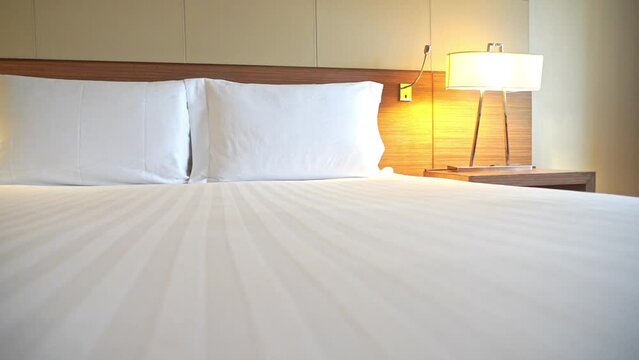 Pan across a hotel bed Mid-century modern lamps.