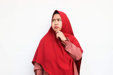 Portrait of attractive muslimah wearing hijab thinking and contemplate looking at copy space...