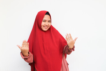 Beautiful muslim woman wearing red hijab over white background inviting to come with hand. Happy that you came