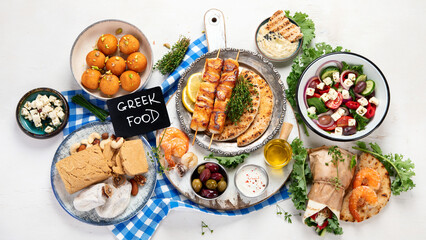 Greek cuisine dishes on neutral background.