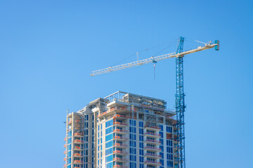 Fototapeta na wymiar Construction crane over tower