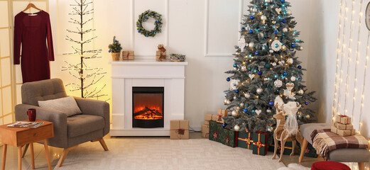 Stylish interior of light living room with Christmas tree and fireplace