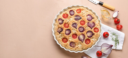 Composition with tasty Italian focaccia, oil and vegetables on beige background with space for text