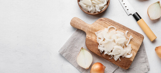 Composition with cutting board and onion on light background with space for text, top view