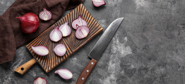 Composition with cutting board, red onion and knife on grunge background with space for text, top view