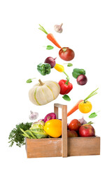 Many healthy vegetables falling into wooden basket on white background