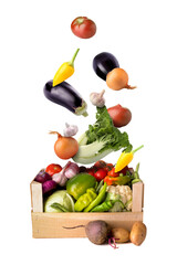 Many healthy vegetables falling into box on white background