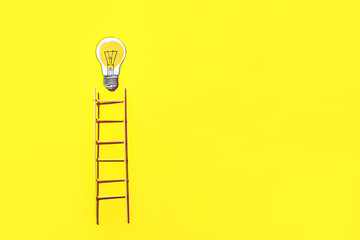 Ladder and light bulb on yellow background