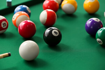 Colorful billiard balls on table, closeup