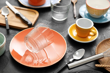 Many different tableware and kitchenware on dark background