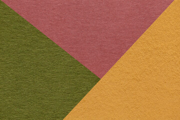Fototapeta premium Texture of craft yellow, green and rose shade color paper background, macro. Vintage abstract cardboard