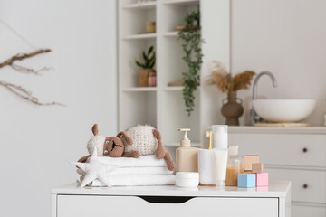 Different bath accessories for children and cute toys in light bathroom
