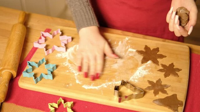 Cooking gingerbread. Closeup girl hands rolling dough on kitchen table.