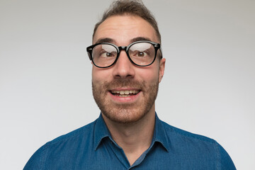 Obraz premium handsome casual man is crossing his eyes, smiling