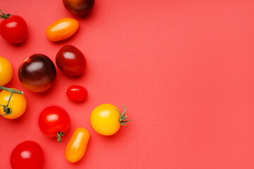 Different fresh tomatoes on red background