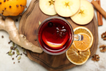 Glass cup of aromatic mulled wine on table, closeup