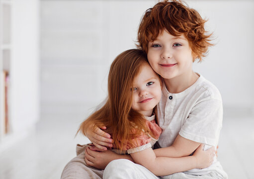 portrait of cute redhead siblings having fun together