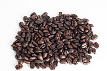 Roasted coffee Beans on white background. Coffee beans close up. Coffee grounds. Freshly roasted coffee beans. Image of a drink made from granules, derived from coffee plant. Copy space for text.