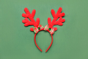 Christmas reindeer horns on green background