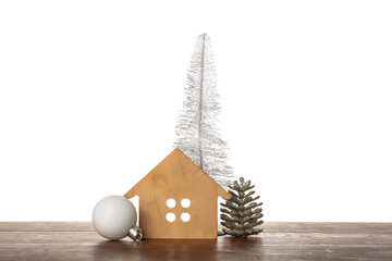 House figure with Christmas decor on table against white background