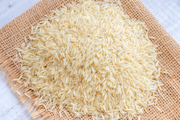 Raw basmati rice, pile of long grain rice 