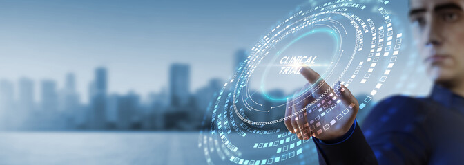 Business, Technology, Internet and network concept. Business man working on the tablet of the future, select on the virtual display: Clinical trial.