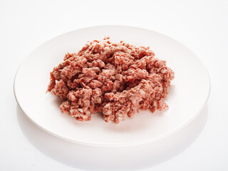 Raw minced meat on the white plate. Fresh pork minced meat on white background. Raw minced pork