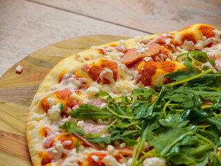 Top quality uncooked Italian pizza with spinach and meat on a wooden tray and table. Cook at home product. Top range ingredients. Classic meal. Close up. Selective focus.