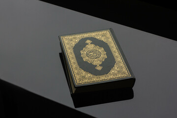 Fototapeta premium The Koran - the holy book of Muslims,placed on a black background.