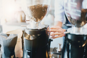 Asian male barista making coffee for customers