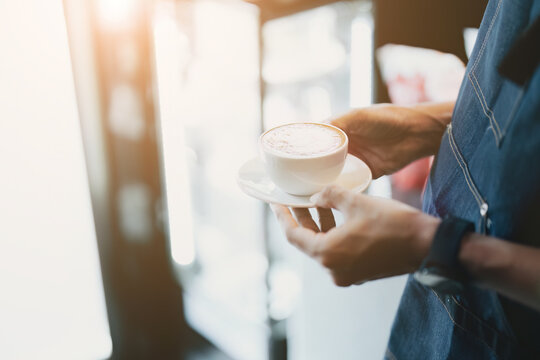 Asian Male Barista Making Coffee For Customers