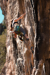 the girl is engaged in rock climbing. sports in nature.