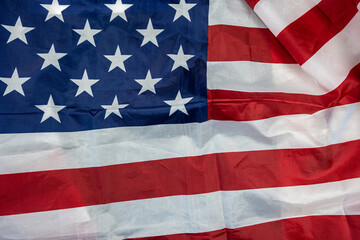 beautiful flag of the United States of America laid out textured on a plain background.